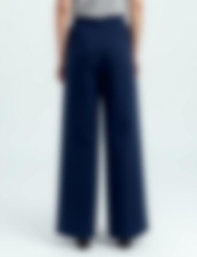 A pair of high-waisted, wide-leg cotton trousers in navy blue.