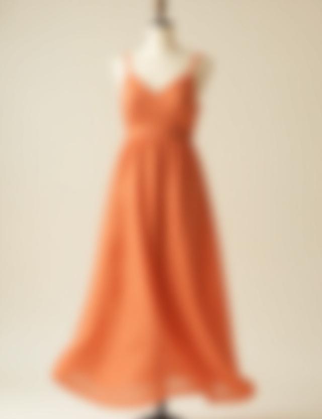 A flowing, hand-dyed linen sundress in a soft terracotta color.
